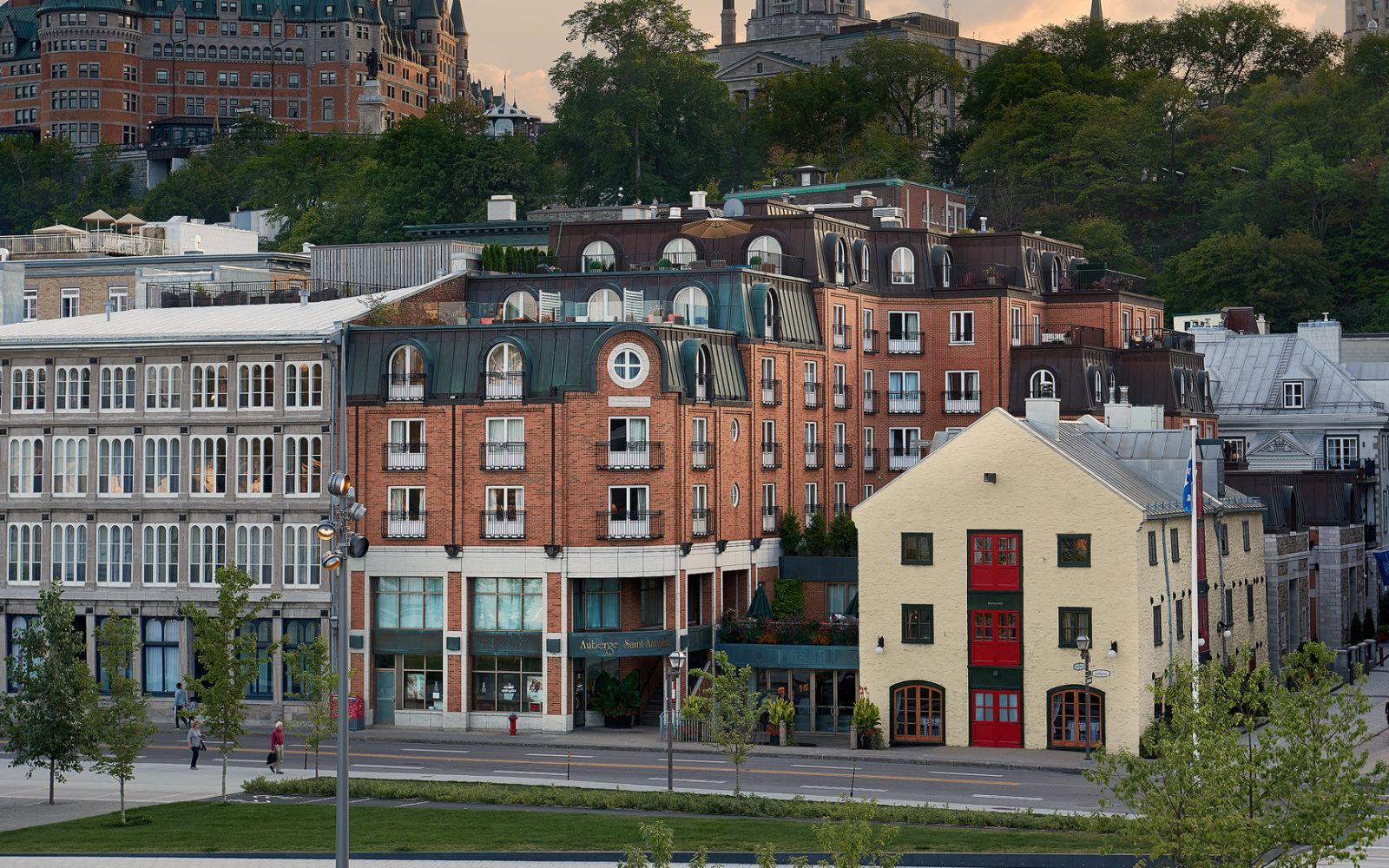 A Group Of Buildings With Trees In The Back