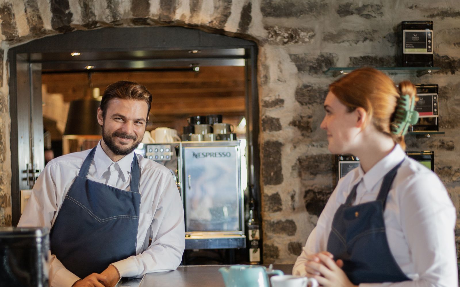 A Group Of People Standing Around A Table