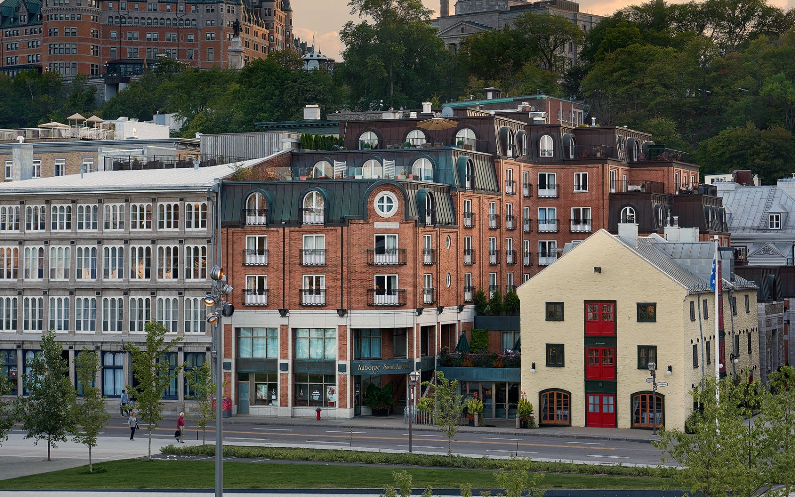 A Group Of Buildings With Trees In The Back